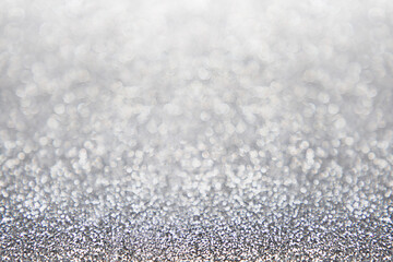 Abstract glitter christmas silver background. Shimmer bright background with bokeh defocused silver...