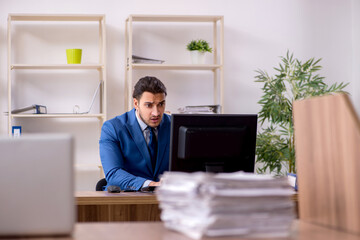 Young male employee unhappy with excessive work