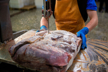 A slaughterhouse worker cut the liver into portions. The concept of sausage and delicatessen...