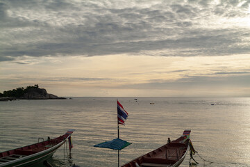 beach and longtail boat at sunset in Koh Tao island, Thailand