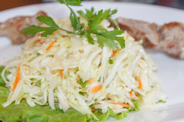 coleslaw on a plate with meat   