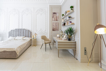 chic luxury interior in an old antique style open-plan apartment decorated with columns and stucco on the wall in pastel colors. tiles on the floor. beige walls
