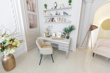 chic luxury interior in an old antique style open-plan apartment decorated with columns and stucco on the wall in pastel colors. tiles on the floor. beige walls