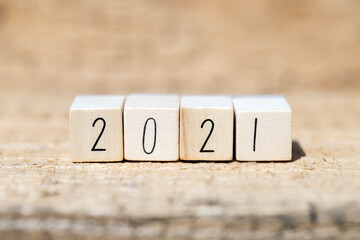 The year 2021 written on wooden cubes, New Years concept or greeting card. wooden background