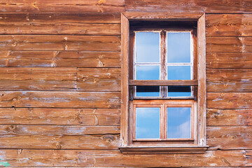 City landscape - view of a wooden wall with a window in an old house, in the Old Town of Nesebar, on the Black Sea coast of Bulgaria