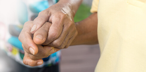 Caregiver, carer hand holding elder hand in hospice care background. Philanthropy kindness to disabled old people concept.Happy mother's day. - obrazy, fototapety, plakaty