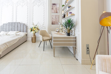 chic luxury interior in an old antique style open-plan apartment decorated with columns and stucco on the wall in pastel colors. tiles on the floor. beige walls