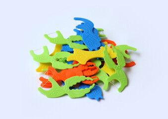 Set of colorful dental floss sticks isolated on a white background.