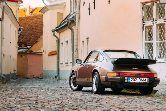 Side View Of Porsche 930 Car Parked In Old Narrow Street.