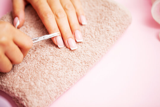 Close up image of woman using nail buffer when doing manicure, polishing nails at home.