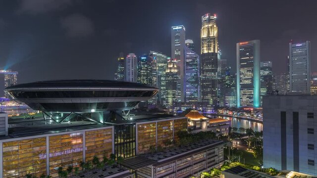 Colorful of Singapore Central business district aerial timelapse cityscape skyline at Marina Bay with illuminated Singapore Academy of Law and Parliament House from above