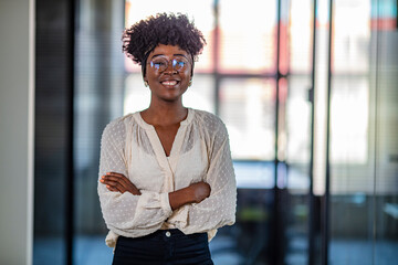 Portrait of a young African ethnicity businesswoman. Businesswoman with arms crossed looking at...