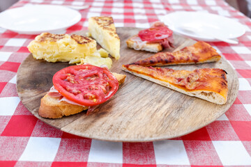 Mediterranean snack in the open air with omelette and pizzas.
