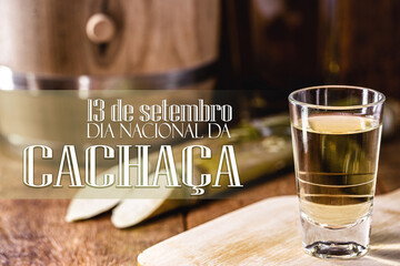Brazilian drink called "cachaça" or "pinga", traditional distilled drink from Brazil, with text in Portuguese: September 13th, national day of cachaça