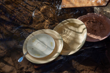 washing dirty dishes in the lake. water supply problem in the village
