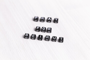 Fototapeta premium Pray for Beirut sign. Show of support in response to 2020 Lebanon Explosion. Message of solidarity and support. Words pray for Beirut on white background.