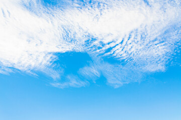 Blurred background. Blue sky and white fluffy clouds.