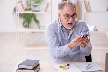 Old male teacher in the classroom