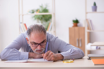 Old male teacher in the classroom