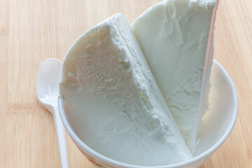 white ice cream in a white plate with a white spoon 