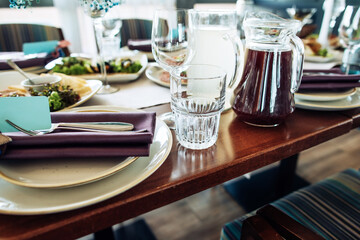 Festive dinner table in the restaurant with food, plates, glasses. Great table set