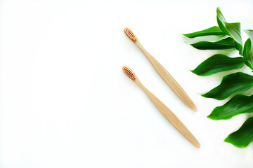 A set of two wooden bamboo toothbrushes decorated with a branch on a white background. Plastic free concept. Zero waste. Copy space.