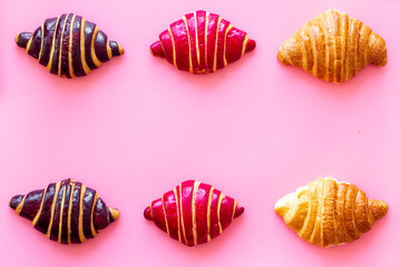 Set of croissants - chocolate, berry, classic - on pink desk top view