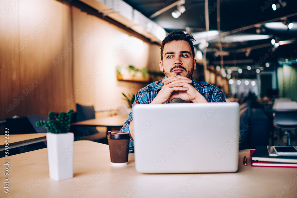Poster thoughtful male software developer feeling pondering on ideas for updating application on laptop com