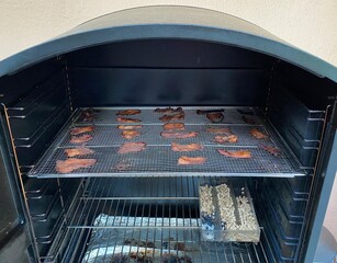Smoker with turkey jerky being made