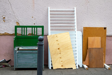 Bulky waste with an old wooden bench, boards and a cot - obrazy, fototapety, plakaty