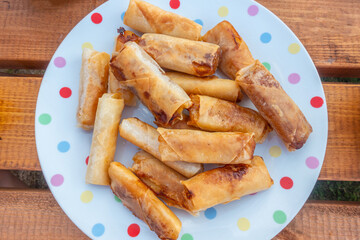 'Spring rolls on a spotty plate.