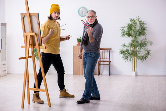 Old man taking lesson from young painter - Powered by Adobe