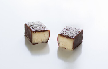 Close up cut chocolate with coconut filling on the white background