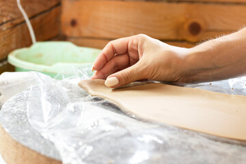 a master of ceramics manually works the bending of the product, close-upp