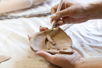 master ceramist works on clay parts, workflow