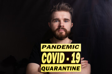 Coronavirus, quarantine, covid-19 and pandemic concept. Sad and sick man of virus looking through the window.