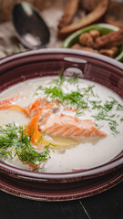 Close-up finnish fish soup with salmon, cream and vegetables. Dishes of the national cuisine of the world. Seafood vertical banner
