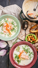 Top view finnish fish soup with salmon, cream, vegetables, fresh herbs and croutons. Traditional national cuisine. Seafood vertical shot