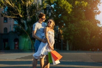 Fototapeta premium husband and pregnant wife shopping in city street