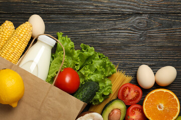 Different food on wooden background, space for text