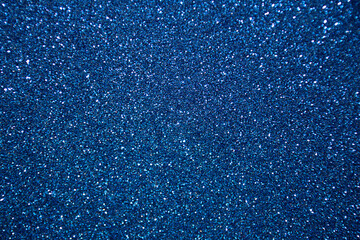 Abstract glitter christmas blue background. Shimmer bright background with bokeh blue lights. Shiny...