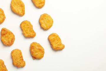 Flat lay with fried chicken nuggets on white background