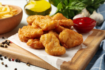 Composition with chicken nuggets, ketchup and potato on white background