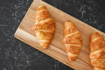 croissant on wooden table, isolated background