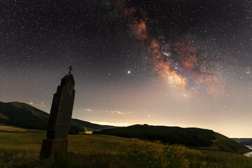 Beautiful night landscape, starry sky with bright milky way galaxy above the lake. Old armenian...