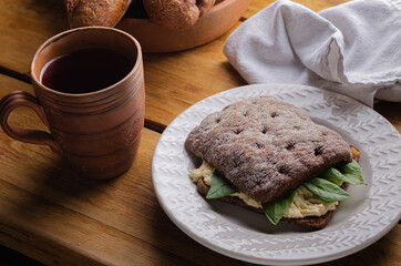 sandwich (bruschetta) made from whole grain bread with cheese and spinach. Healthy snack, healthy food.