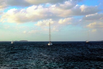 Greece, Antiparos island, sailing boats on the Aegean sea.
