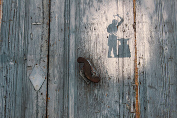 Silhouette of a blacksmith at a door
