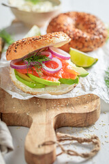 Delicious bagel with avocado, salmon and dill for fresh lunch