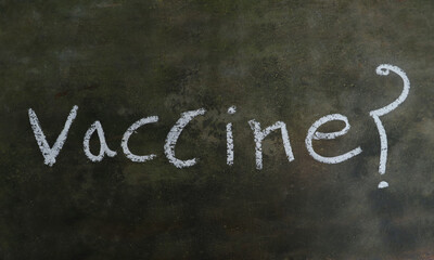 Vaccine Word with Question Mark  Written on Blackboard with White Chalk